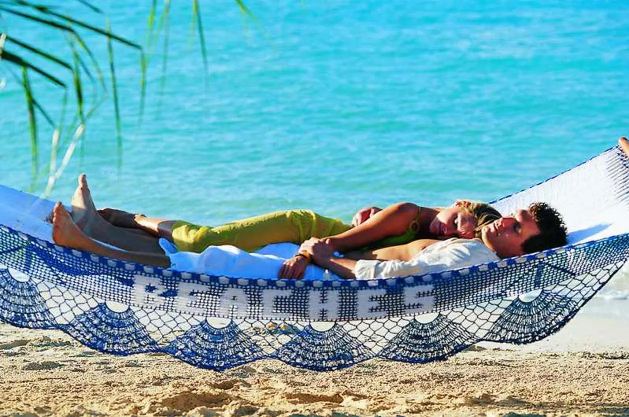 Couple on beach hammock at Azul Beach Resort Negril Jamaica